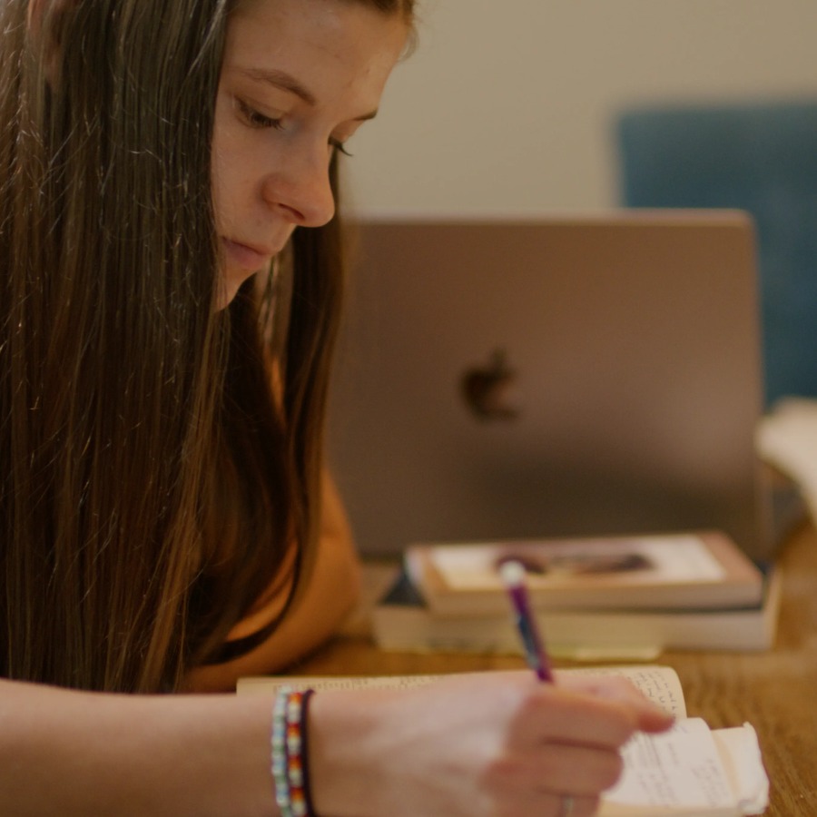 A young woman writing in her journal